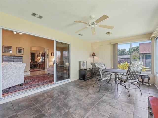 sunroom featuring ceiling fan