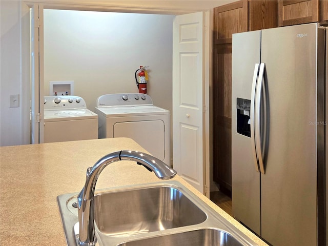 laundry area featuring washer and clothes dryer, washer hookup, and sink