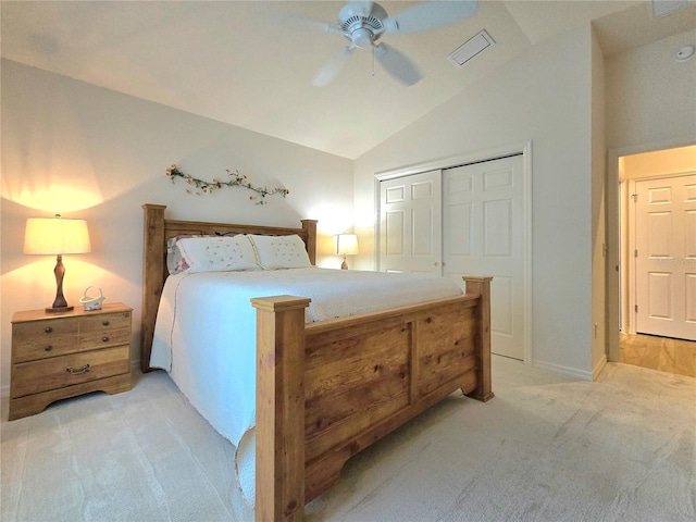 bedroom featuring light carpet, lofted ceiling, ceiling fan, and a closet