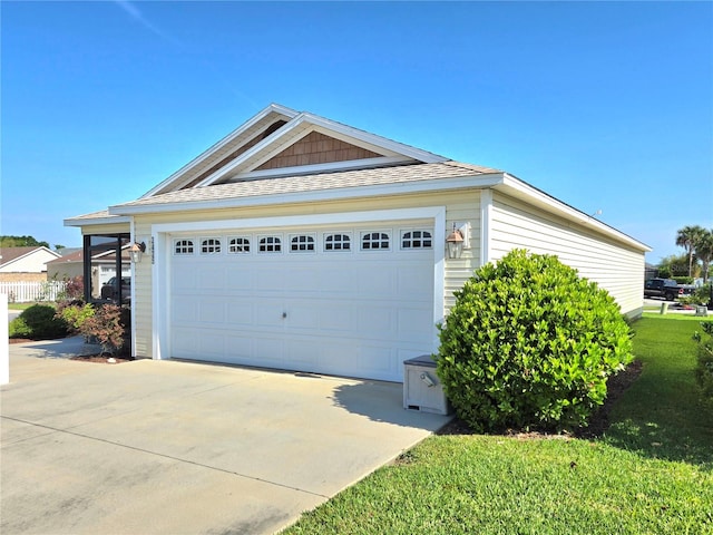 exterior space featuring a garage and a yard