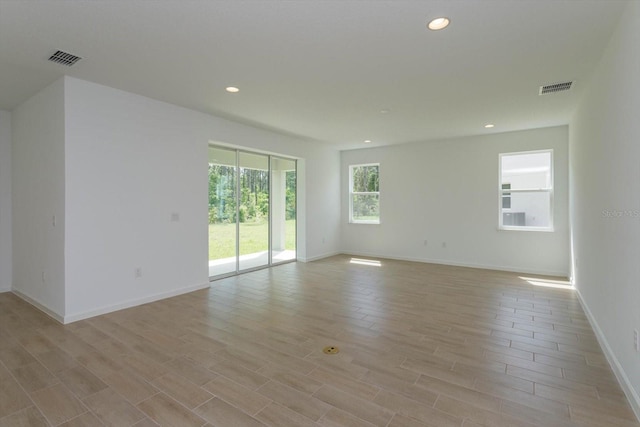 spare room featuring light hardwood / wood-style floors