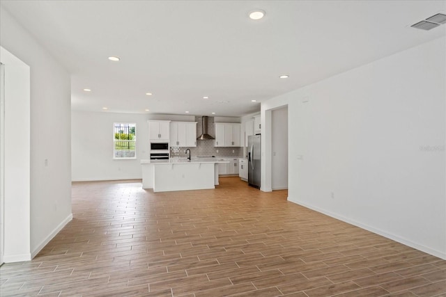 unfurnished living room with sink