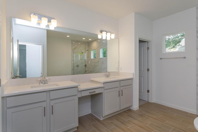 bathroom with walk in shower, double sink, and large vanity