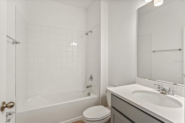 full bathroom with tiled shower / bath, toilet, and vanity