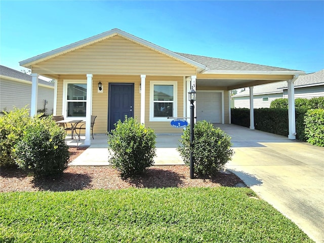 view of front of property featuring a garage, a carport, and a porch