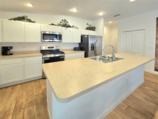 kitchen featuring light hardwood / wood-style flooring, sink, stainless steel appliances, and an island with sink