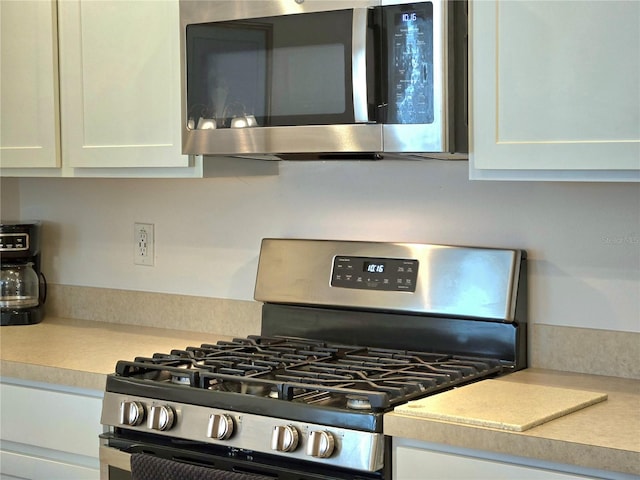 kitchen with appliances with stainless steel finishes and white cabinetry