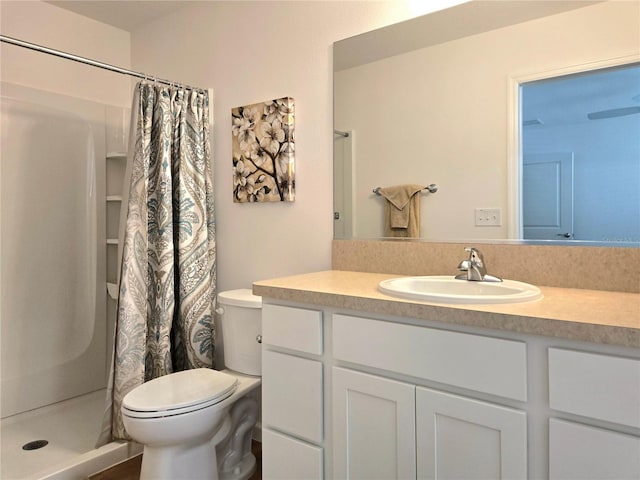 bathroom with a shower with curtain, toilet, and large vanity