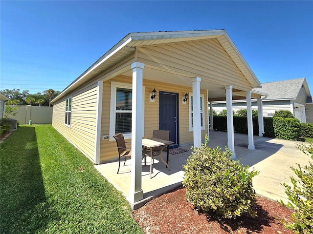 back of property featuring a porch and central AC