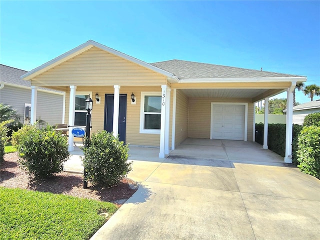 ranch-style house with a carport, a garage, and covered porch