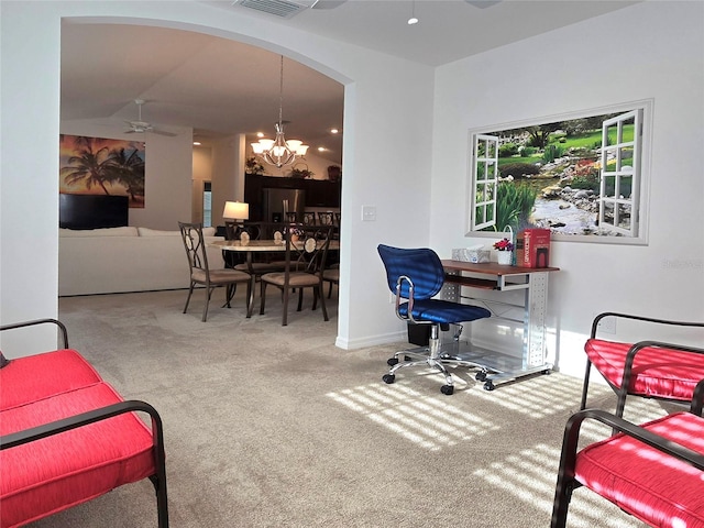 carpeted office space with ceiling fan with notable chandelier