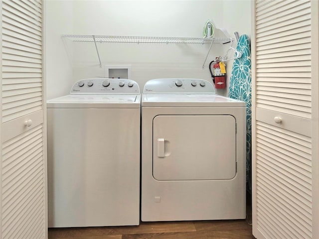 laundry area with washing machine and dryer, washer hookup, and dark hardwood / wood-style floors