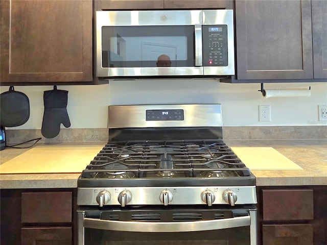 kitchen featuring dark brown cabinets and stainless steel appliances