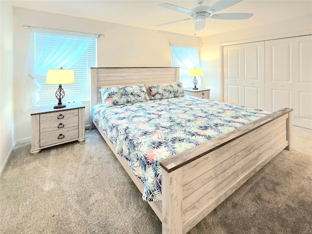 bedroom with a closet, ceiling fan, and carpet flooring