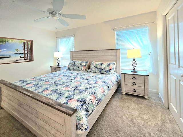 carpeted bedroom with a closet and ceiling fan