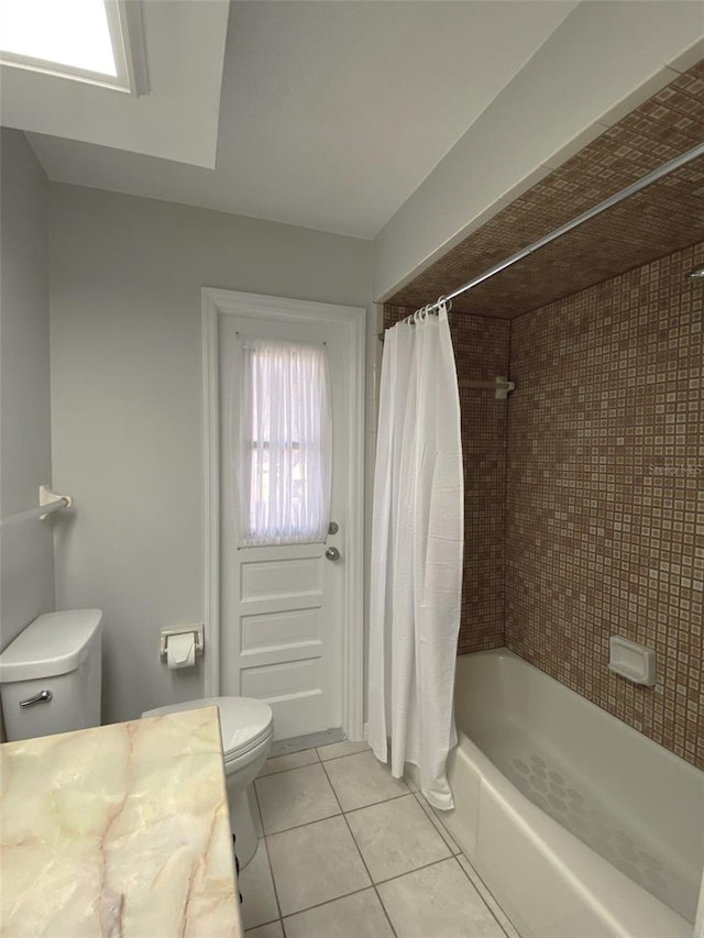 full bathroom featuring tile patterned flooring, vanity, toilet, and shower / tub combo with curtain