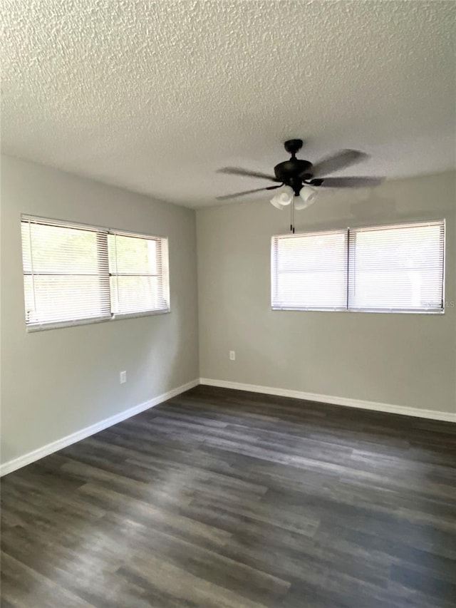 spare room featuring a textured ceiling, ceiling fan, and dark wood-type flooring