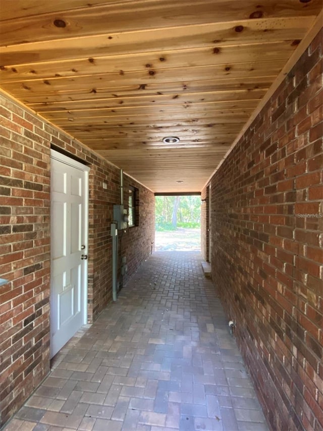1921 Smitty Rd, Weirsdale, FL 32195 - corridor with wood ceiling, brick wall, and brick floors