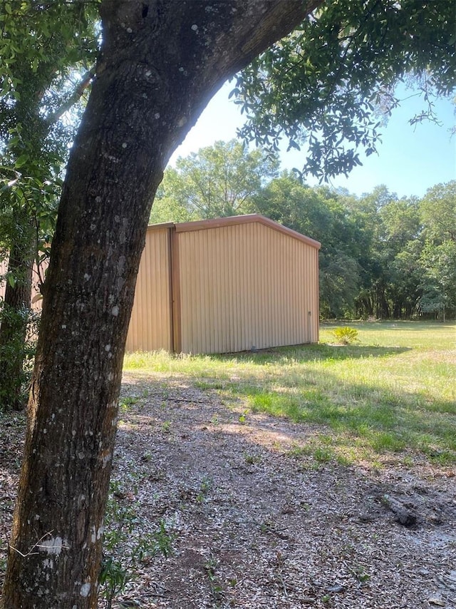 1921 Smitty Rd, Weirsdale, FL 32195 - view of yard featuring an outdoor structure, an outbuilding, and a wooded view