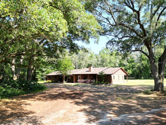 1921 Smitty Rd, Weirsdale, FL 32195 - ranch-style home with a chimney and dirt driveway