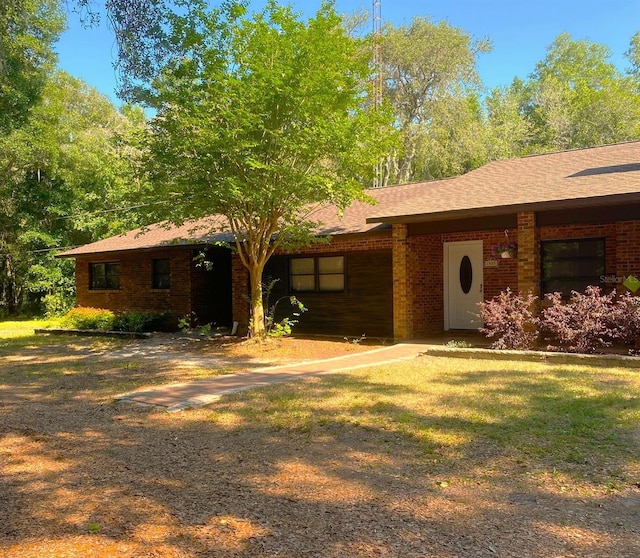 1921 Smitty Rd, Weirsdale, FL 32195 - view of front facade with brick siding and roof with shingles