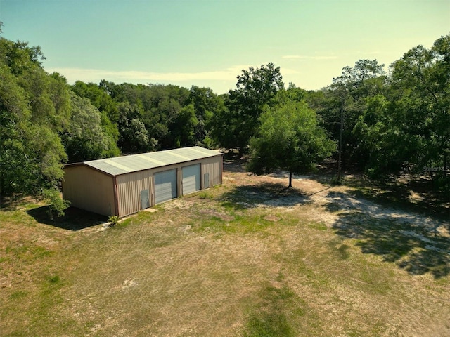 1921 Smitty Rd, Weirsdale, FL 32195 - view of yard with a detached garage, an outbuilding, and a wooded view