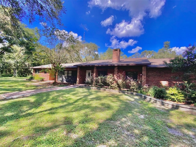 1921 Smitty Rd, Weirsdale, FL 32195 - ranch-style home featuring brick siding, a chimney, and a front lawn