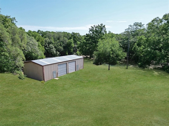 1921 Smitty Rd, Weirsdale, FL 32195 - view of grassy yard featuring a garage, an outbuilding, and a view of trees