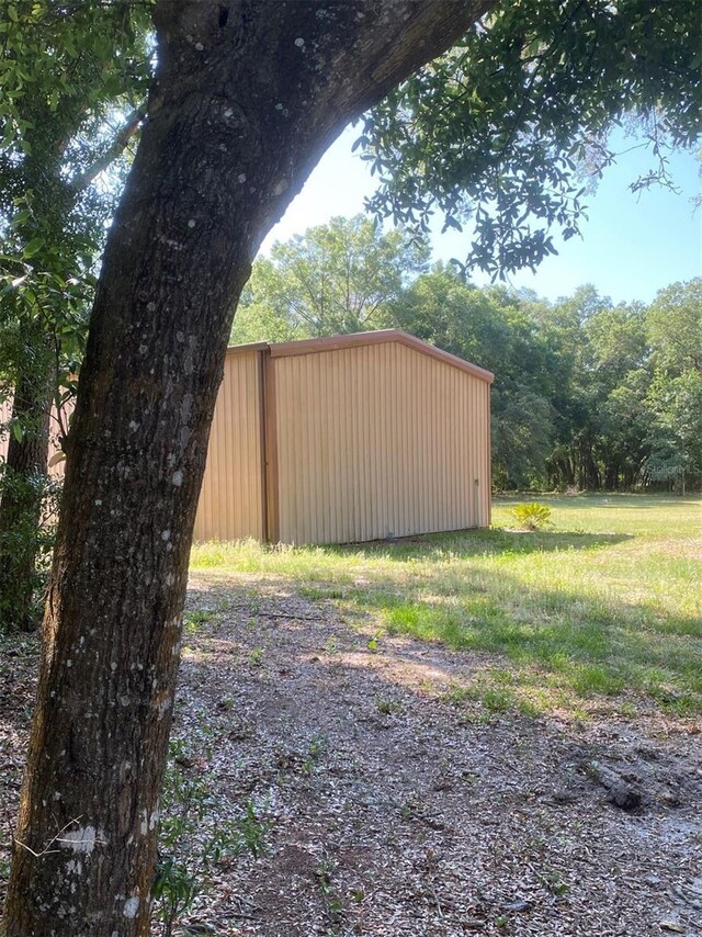 1921 Smitty Rd, Weirsdale, FL 32195 - view of yard featuring an outbuilding and a forest view