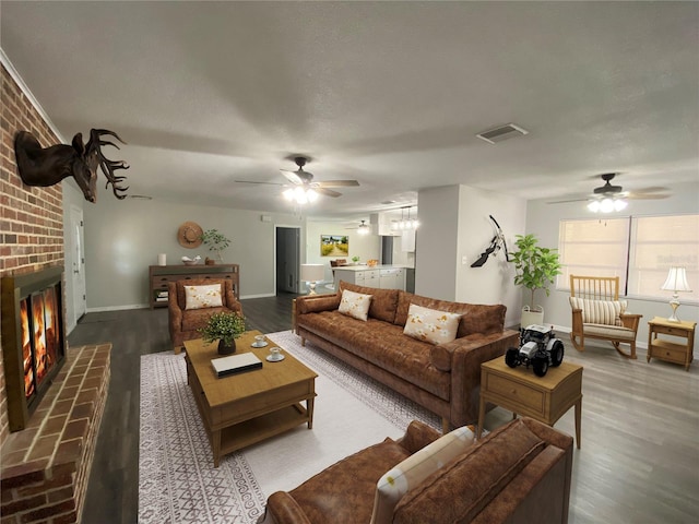 1921 Smitty Rd, Weirsdale, FL 32195 - living area featuring ceiling fan, dark wood finished floors, and a brick fireplace