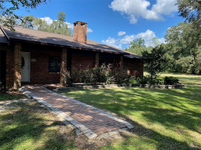 1921 Smitty Rd, Weirsdale, FL 32195 - rear view of property with brick siding, a yard, and a chimney