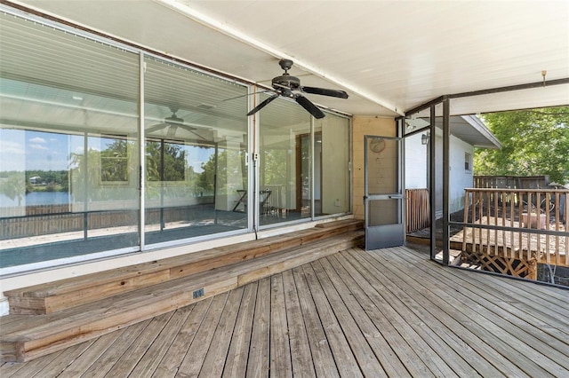 wooden terrace with ceiling fan and a water view