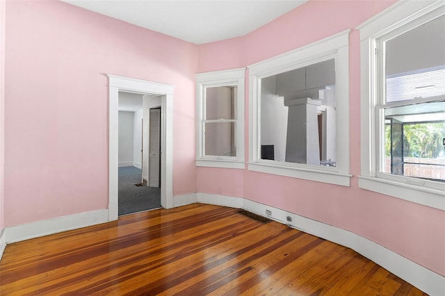 spare room featuring wood-type flooring