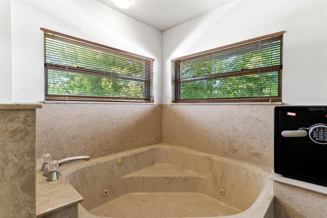 bathroom with plenty of natural light and a bathtub