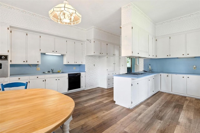 kitchen featuring white cabinetry, dark wood-type flooring, pendant lighting, and black dishwasher