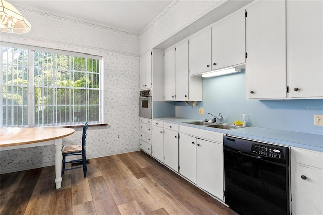 kitchen with dishwasher, oven, sink, dark hardwood / wood-style flooring, and white cabinetry