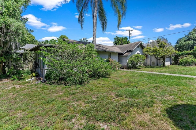 view of property exterior with a lawn