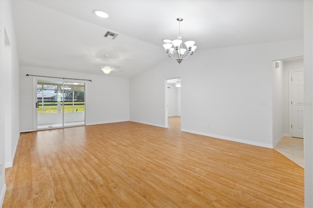 empty room featuring lofted ceiling, light hardwood / wood-style flooring, and ceiling fan with notable chandelier