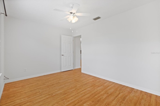 unfurnished room with light wood-type flooring and ceiling fan