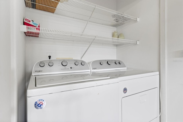 clothes washing area with separate washer and dryer