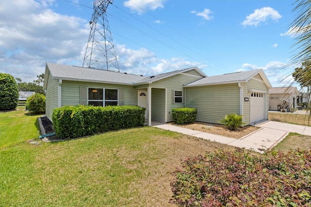 ranch-style house with a garage and a front lawn