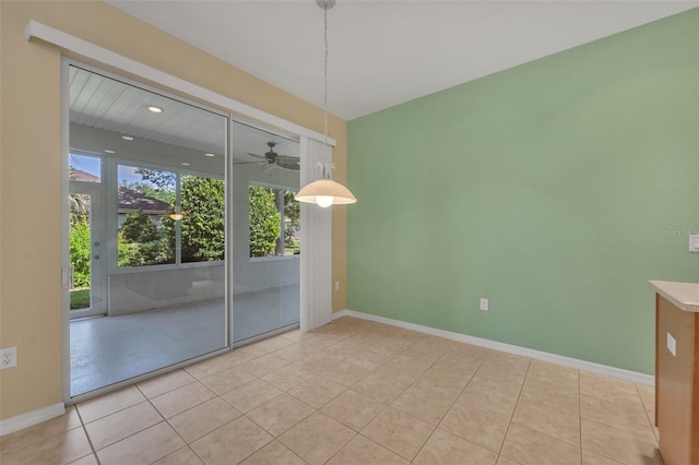 empty room featuring ceiling fan and light tile flooring