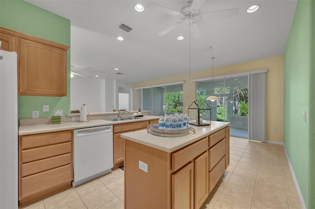 kitchen with decorative light fixtures, white appliances, sink, a kitchen island, and ceiling fan