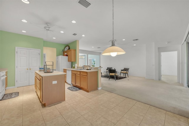 kitchen with a kitchen island, decorative light fixtures, white appliances, and light tile floors