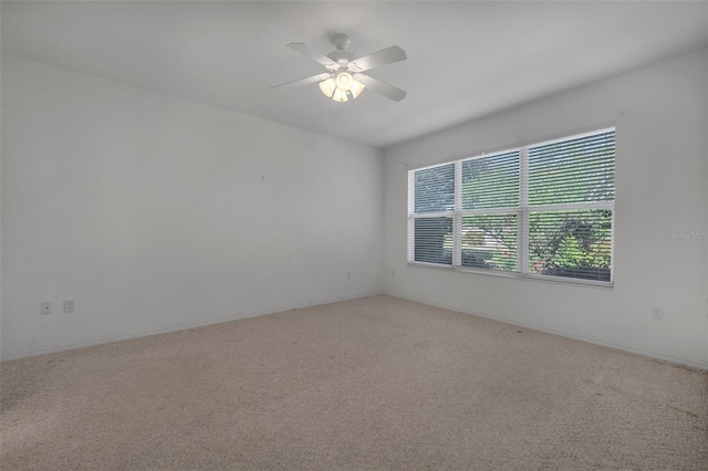 unfurnished room with carpet and ceiling fan