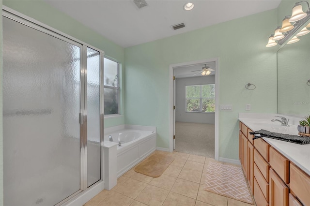 bathroom with tile flooring, ceiling fan, vanity, and plus walk in shower