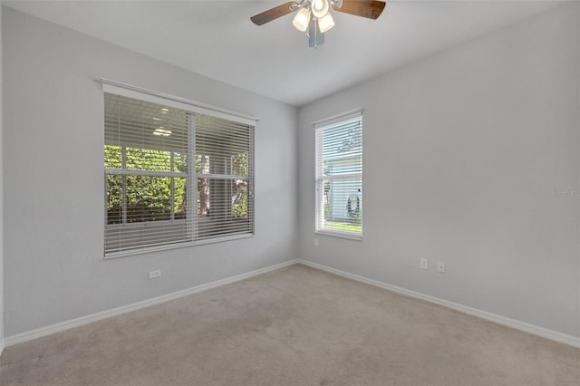 spare room with ceiling fan and carpet floors