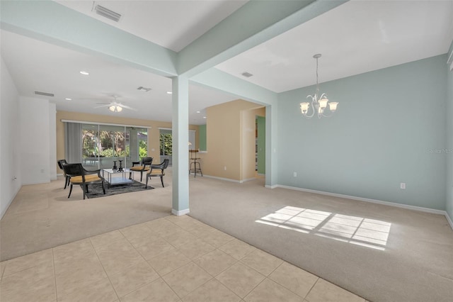 empty room with ceiling fan with notable chandelier and light tile floors