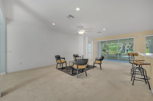 carpeted dining space featuring ceiling fan