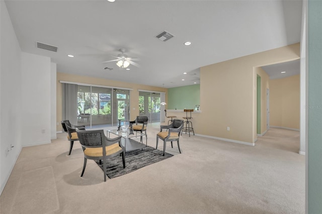 carpeted living room with ceiling fan